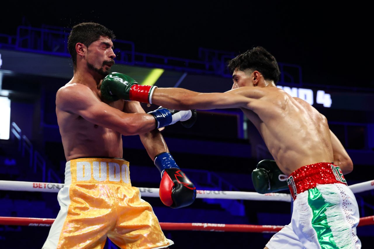 Jose Medrano Jr lands a straight punch on Anel Dudo during their featherweight contest in San Jose.
